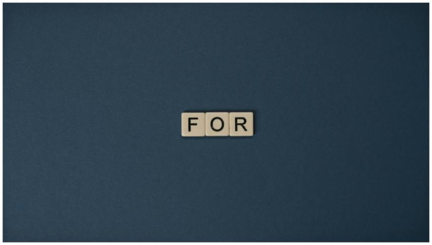 Artistic display of Scrabble tiles spelling the wo