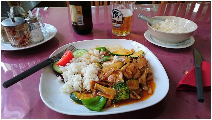 Tasty Asian pork dish with vegetables and rice ser
