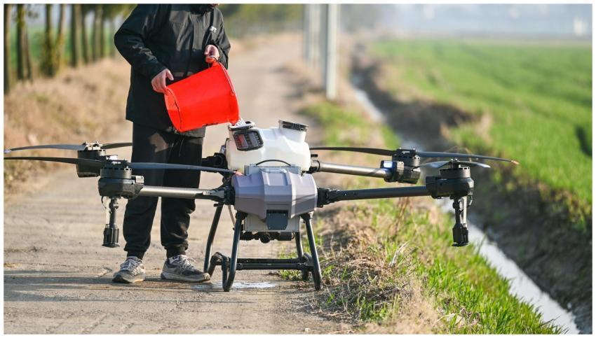 Person using a drone for agricultural purposes on