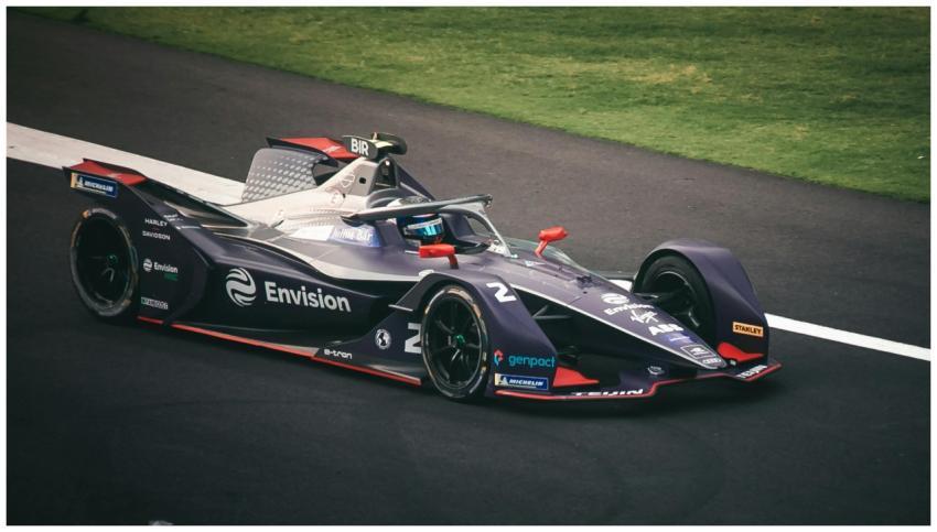 Dynamic image of a Formula E car racing on the tra