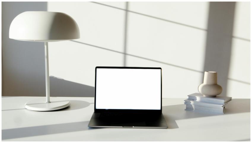 Sleek office desk setup featuring laptop, modern l