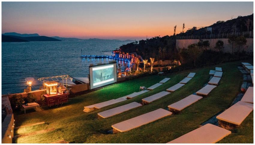 Beautiful evening outdoor movie setup by the sea i