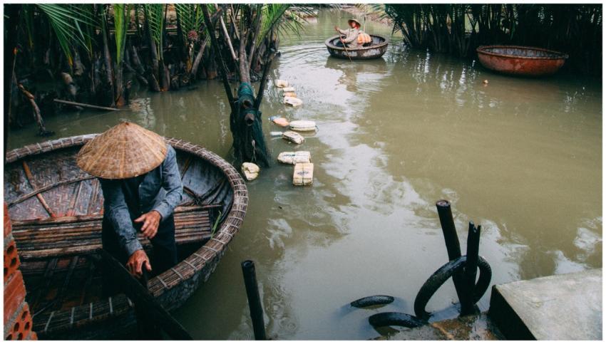 Men rowing traditional basket boats in rural Vietn