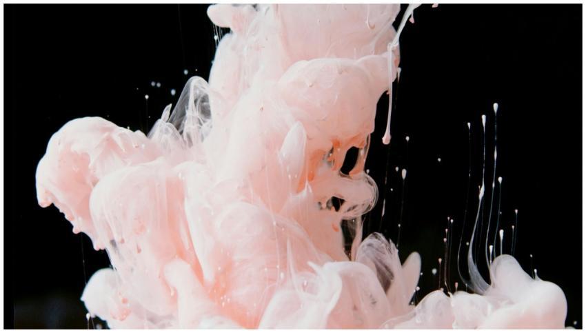 Stunning capture of pink ink swirling in water, cr