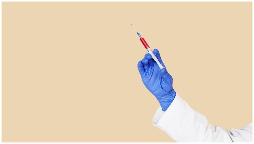 Unrecognizable healthcare worker holding a syringe