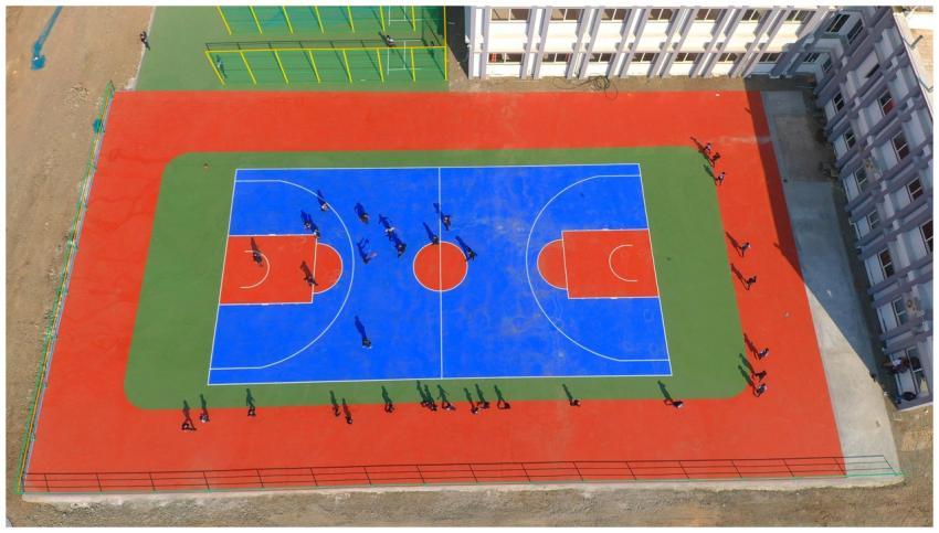 Drone image of a vibrant basketball court with pla