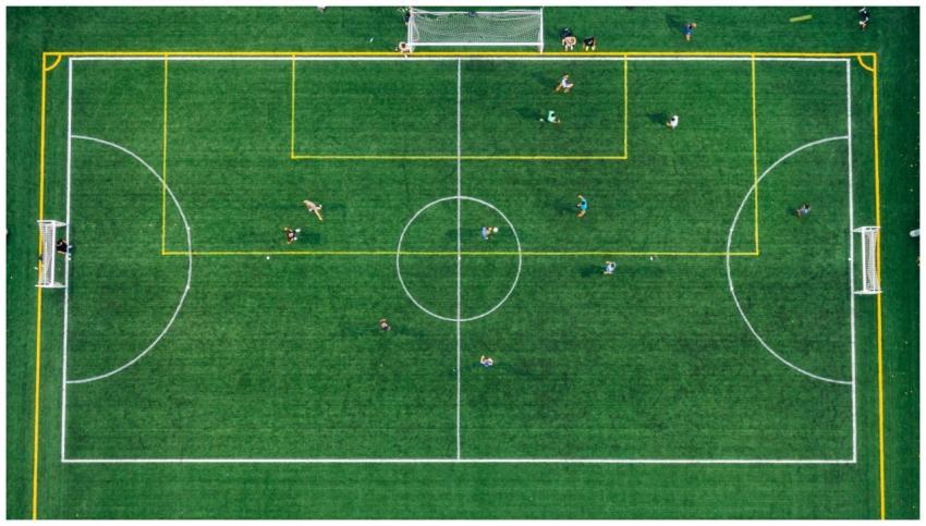 High aerial view of a soccer field with players du