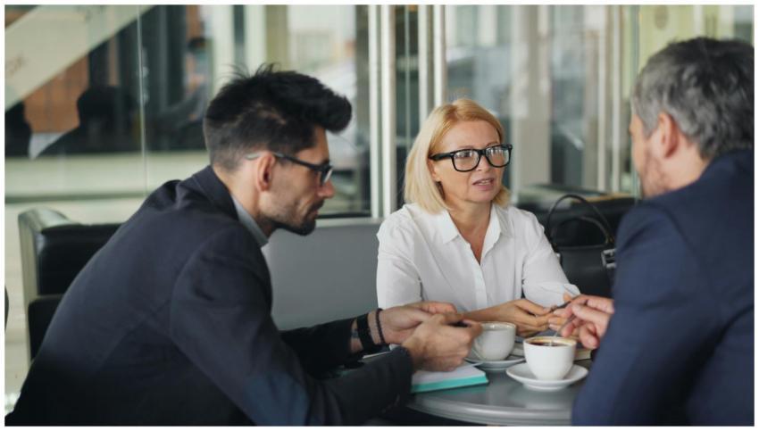 Professional team discussing ideas over coffee in
