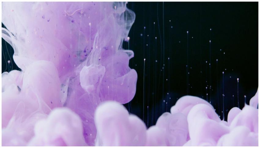 Ethereal pink and purple ink swirling in dark wate