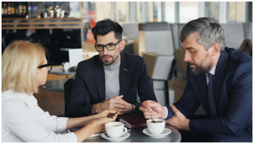 Professional meeting with three businesspeople dis