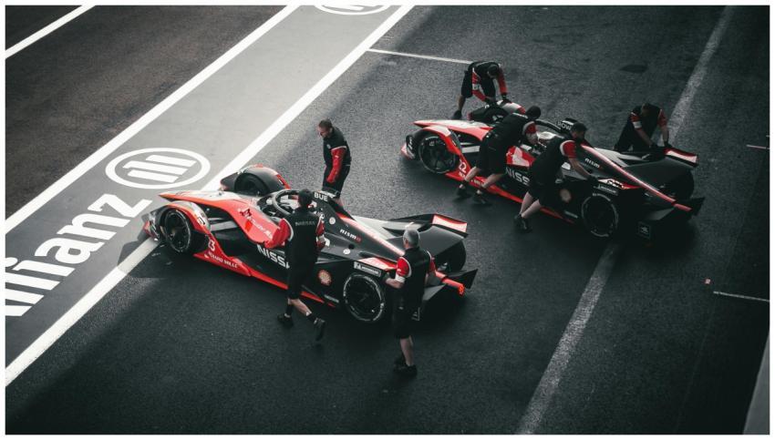 Pit crew working on race cars at a motorsport even