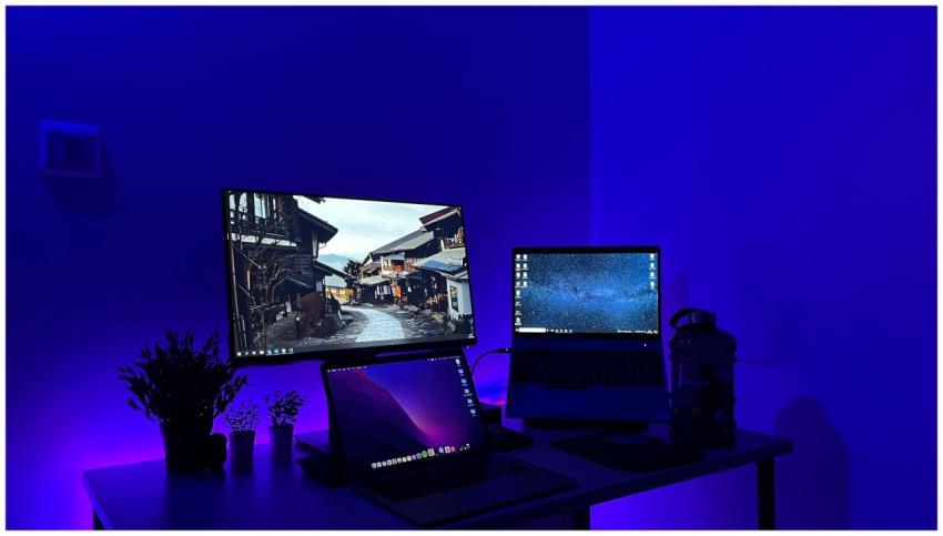 Sleek gaming desk setup with multiple screens and