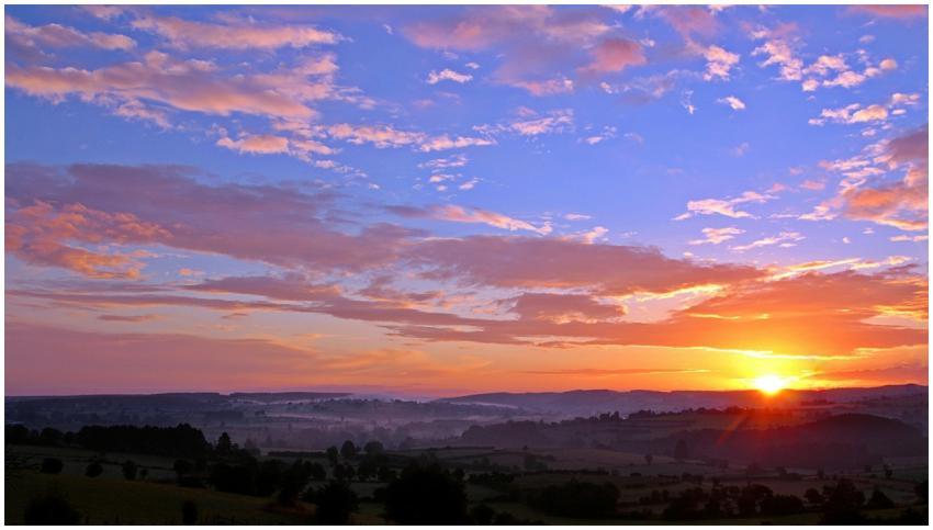 Stunning sunrise over rolling hills with colorful