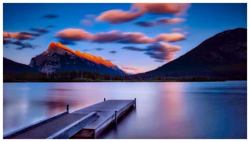 Breathtaking sunset view with mountains reflecting