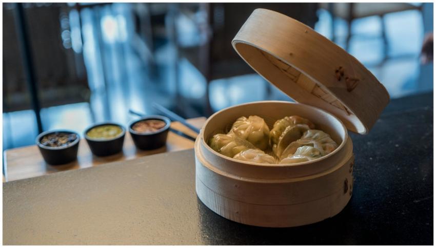 Close-up of steaming dim sum dumplings in a bamboo