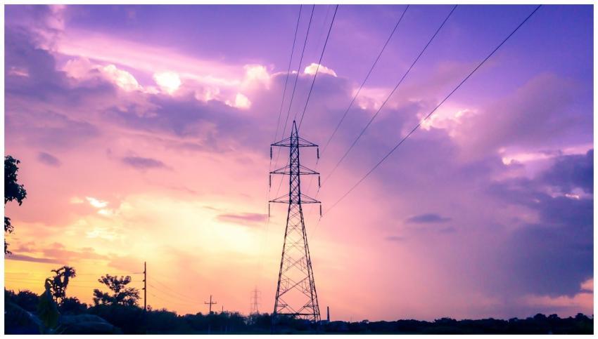 Silhouette of power lines at sunset against vibran
