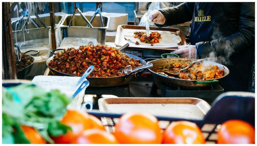Candid shot of a chef preparing delicious street f