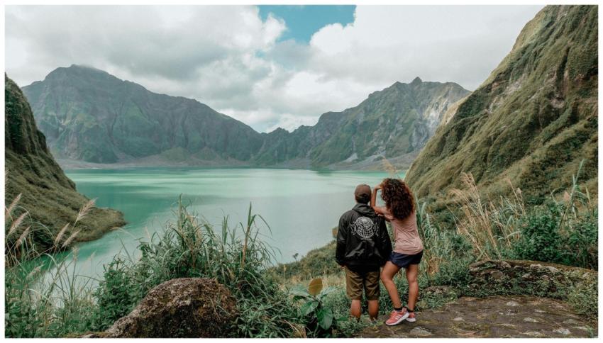 Couple enjoying the view of a beautiful lake amid
