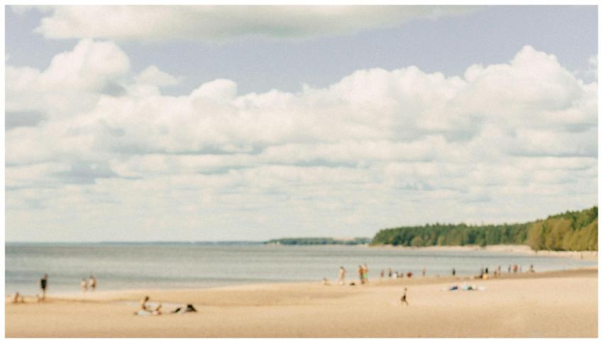A serene beach scene with tourists relaxing under