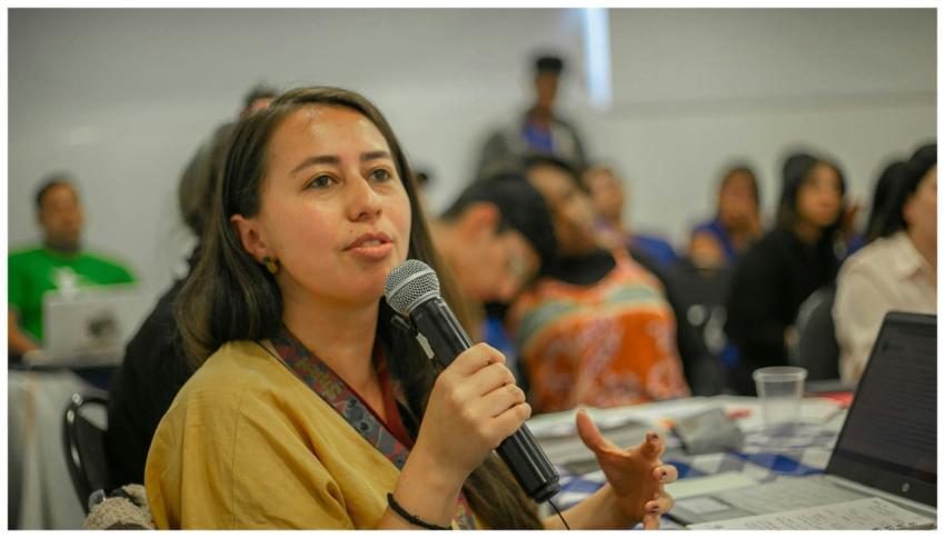 Young woman with microphone speaking during a clas