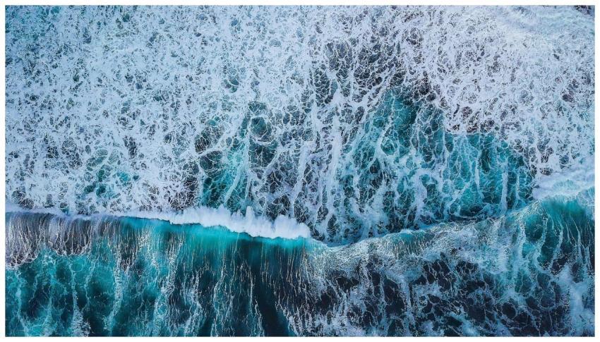 Captivating aerial view of blue ocean waves crashi