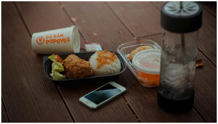 A tasty Popeyes meal featuring fried chicken, rice