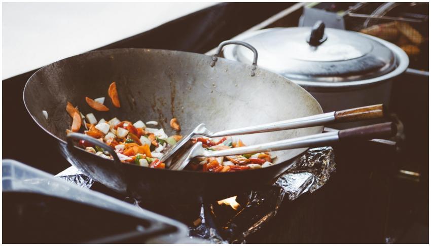 Colorful stir-fry vegetables cooking in a wok on a