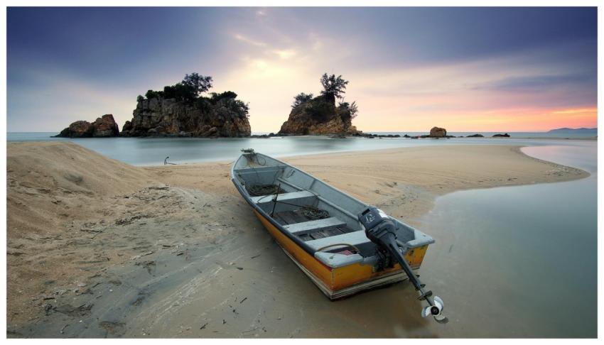 A peaceful seashore scene featuring a fishing boat