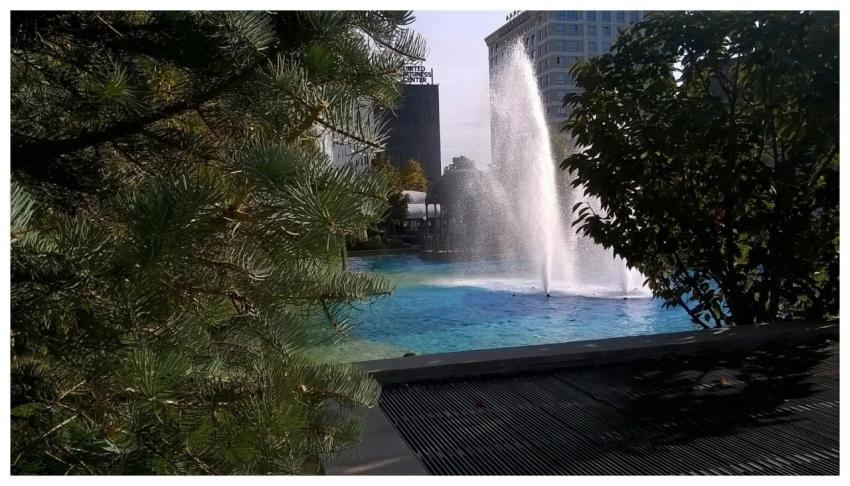 Scenic view of a fountain surrounded by trees in I