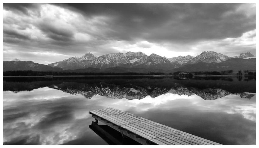 Monochrome landscape of mountains reflecting on a