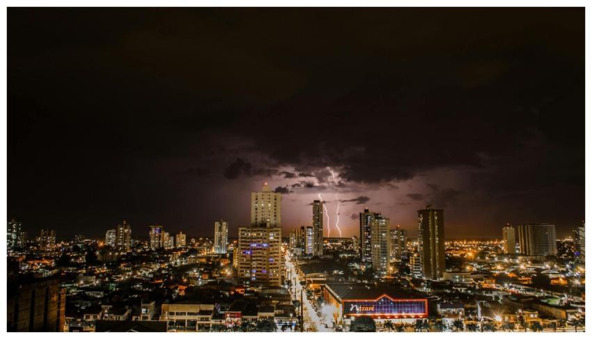 A vibrant city skyline illuminated by lightning ag