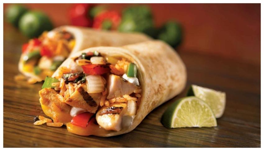 Close-up of a savory chicken burrito with fresh li