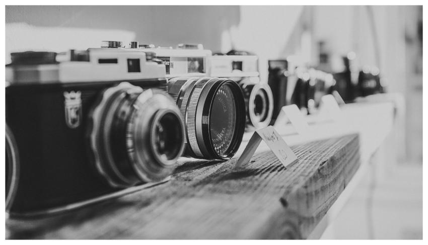 Capture of vintage cameras displayed in black and