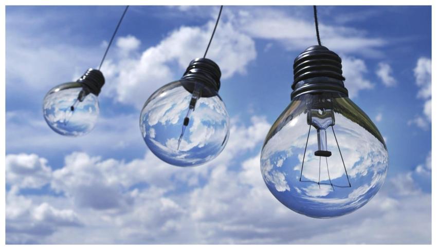 Surreal image of light bulbs reflecting blue sky a