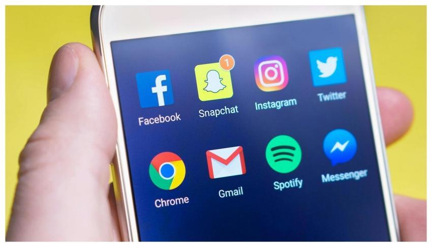 A person's hand holding a smartphone displaying so