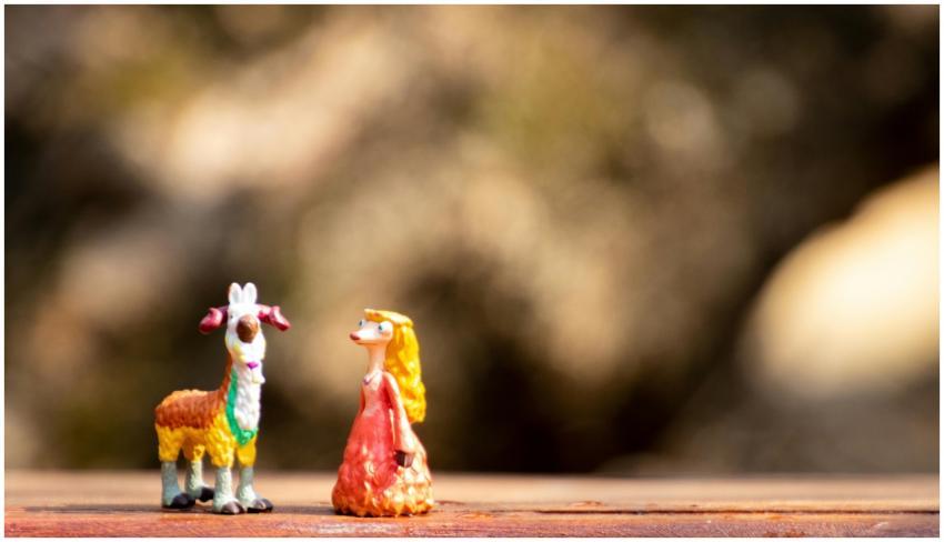 Playful miniature goat and whimsical character fig