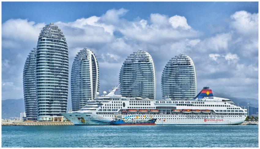 A modern city skyline with a cruise ship docked at