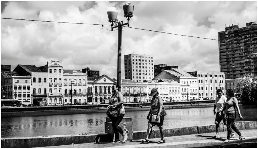 Black and white photo of people walking by histori