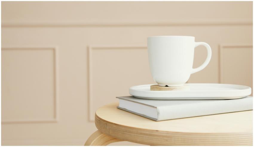 A white ceramic mug on a tray, placed over a close