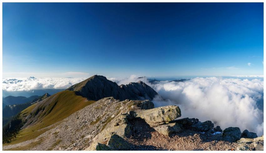 A breathtaking view of a rocky mountain peak risin