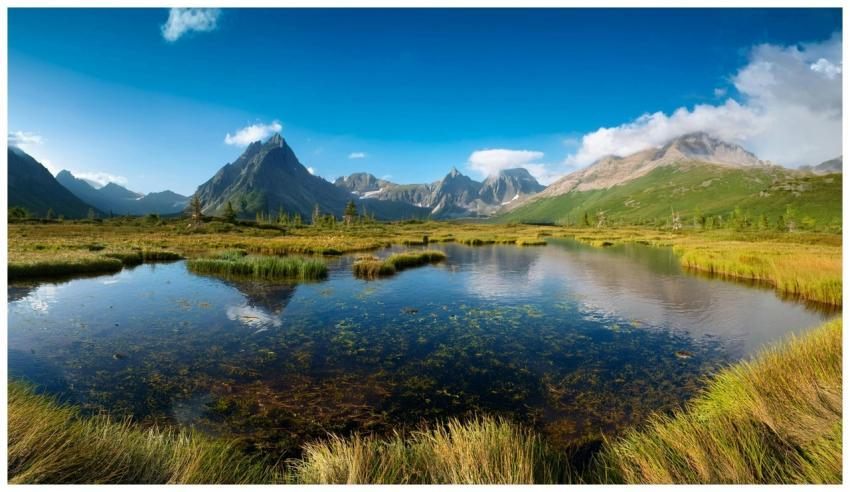 A serene alpine lake reflecting majestic mountains