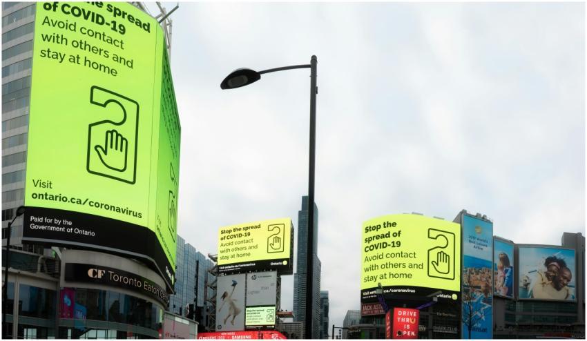 From below of modern buildings with billboards abo