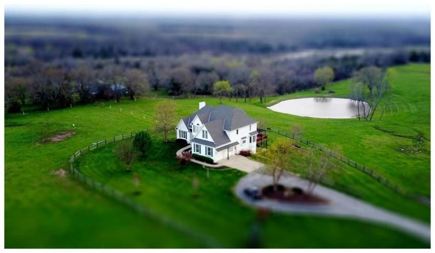 Aerial shot of a charming rural home surrounded by