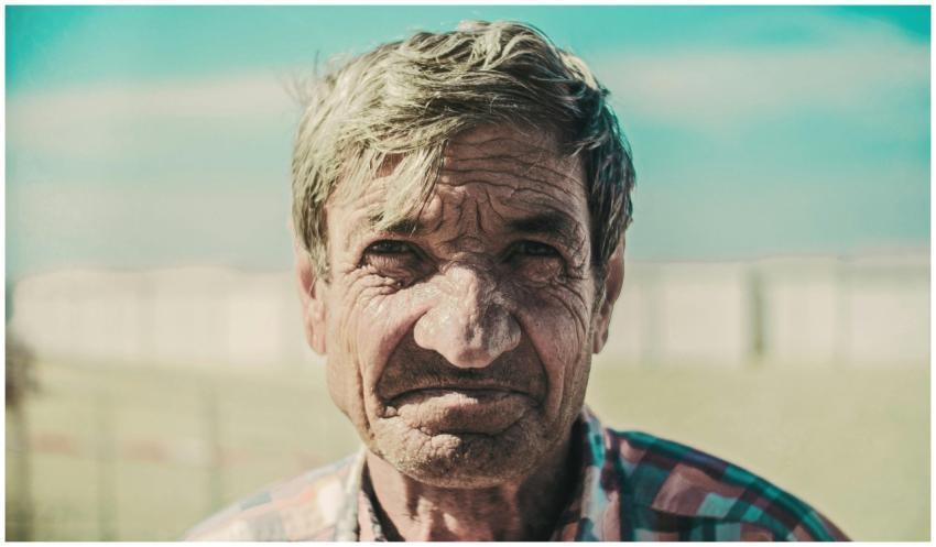Close-up portrait of an elderly man with wrinkles,