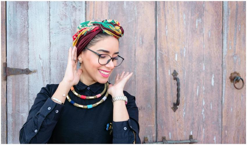A fashionable woman with a headscarf and necklace