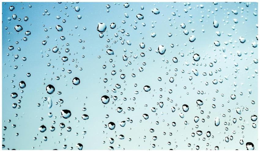 Close-up view of water droplets on glass against a