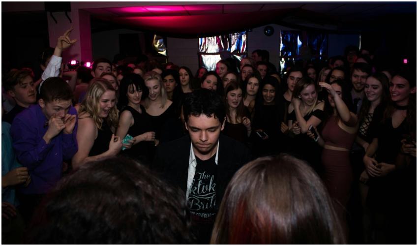 A lively group of young adults dancing and enjoyin