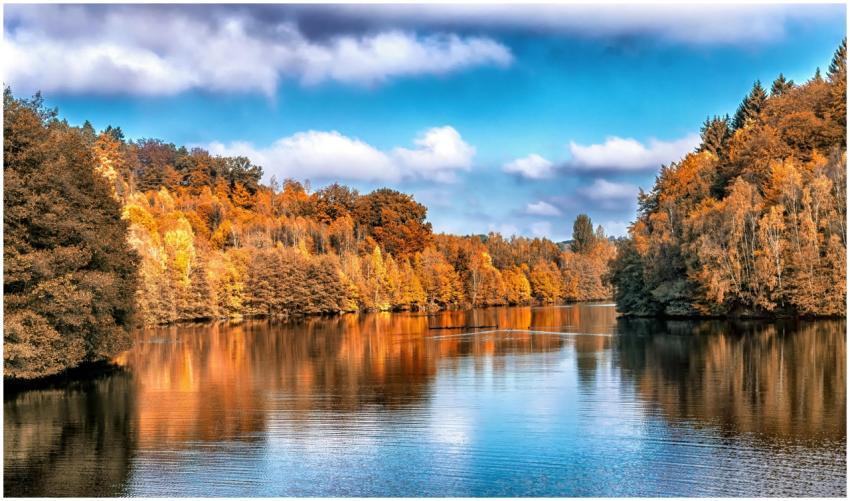 Autumn landscape showcasing vibrant foliage reflec