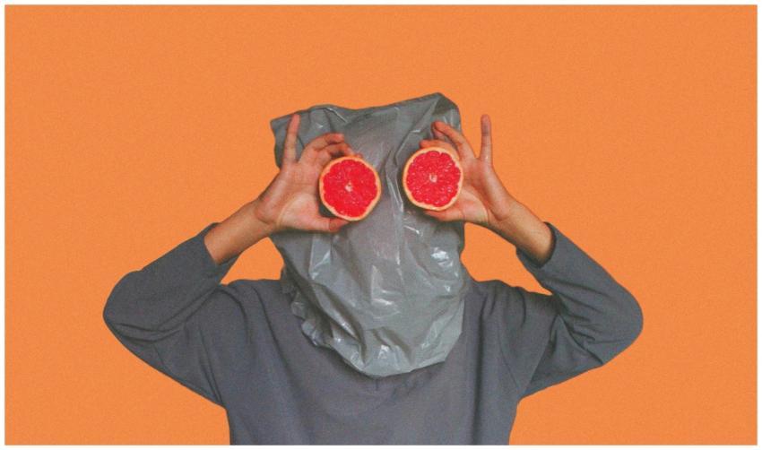 Whimsical portrait featuring grapefruit slices hel