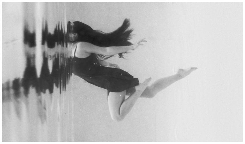 Ethereal black and white underwater shot of a woma